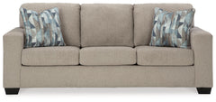 Youâ€™re in for a neat treat with this sofa. Its comfy seats are covered in soft, textural upholstery, and the wide track arms are eager to support your quest for total relaxation. Distressed abstract toss pillows bring a fresh breath of contemporary styl