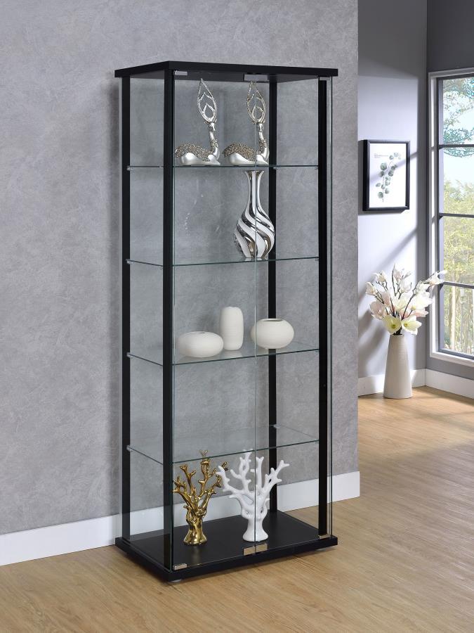 Transparency and linear styling make this curio cabinet stand out and shine. Simple design work blends straight lines with a slender black frame and tempered glass shelves. Push-to-open doors offer easy access to interior shelving. Put your best decor on 