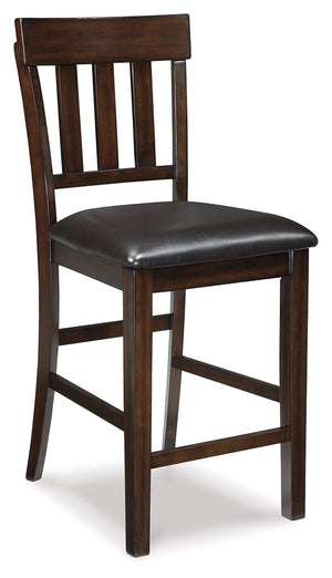 Modern sophistication, beautifully served. This bar stool raises the bar with a cool, rake back design with staggered rungs for added interest. Dark and rich, the monochromatic finish enhances its sleek profile. Faux leather seat upholstery offers easy-ca