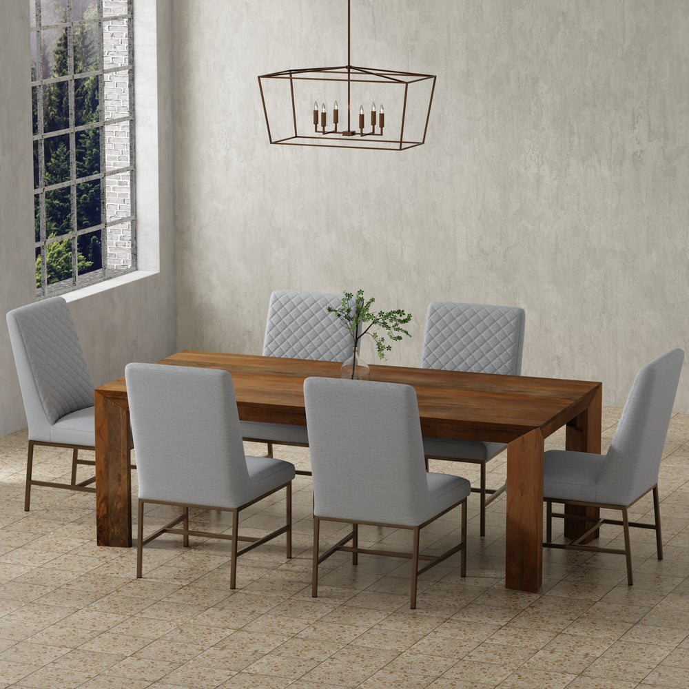 Crafted from solid mango, this table boasts a unique aesthetic with natural variations of color, wood grain, and knots. The geometric mitered edge creates a seamless transition between the table top, apron, and angled legs, and is generously proportioned 