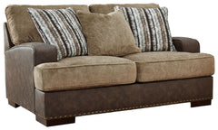 Punctuated by a subtle band of nailhead trim, this loveseat is perfect for those who love the look of leather. Two textural tones provide twice the style and comfortâ€”and incorporate an added layer of visual interest. Throw pillows add a fun decorative e