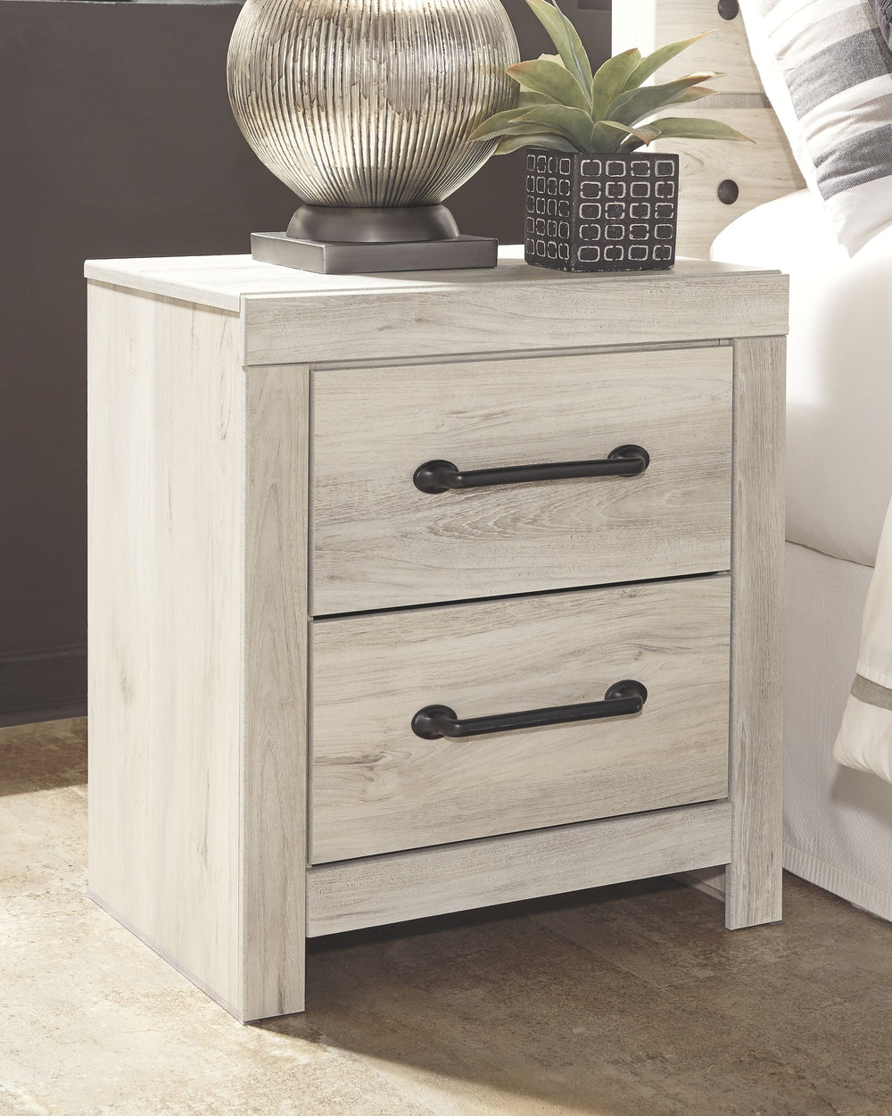 What a delightful take on rustic industrial style. Whether modern loft or modern farmhouse, this nightstand makes itself at home. The wispy whitewash palette enhances without covering the grain for that weathered look you crave. Elongated drawer pulls ele