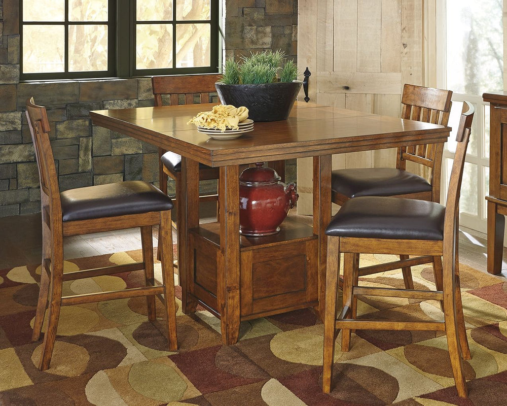 Have an appetite for clean-lined design, but with warmth and rustic character? Satisfaction is served with this counter height extension dining room table. We love how its gently distressed, burnished finish and shelf-style pedestal incorporate depth and 