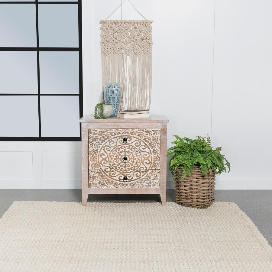An ornate medallion brings boho charm and artisan character to a farmhouse accent cabinet. Easily doubling as a side table, the cabinet features three drawers perfect for tucking away essentials and accessories in a tidy living area or bedroom. A whitewas