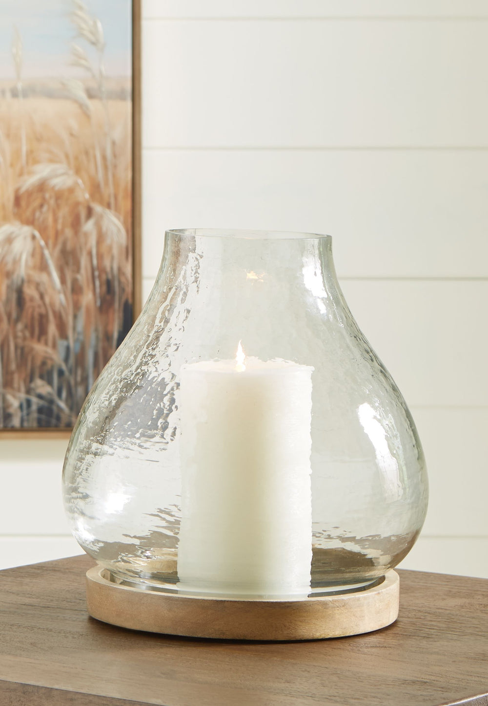 The warbled texture of this glass candle holder gives it a casual, rustic charm. Add a pillar candle in the color of your choice, or use a white candle for that classic look. The hurricane candle holder creates a lovely ambiance when placed on a dining ta