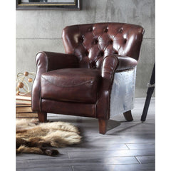 The Brancaster accent chair invites you to sit back and relax for hours on end. A timeless design, this armchair features vintage brown top grain leather upholstery with button-tufted accents, rolled arms, and tapered wood legs. Whether your decor leans t