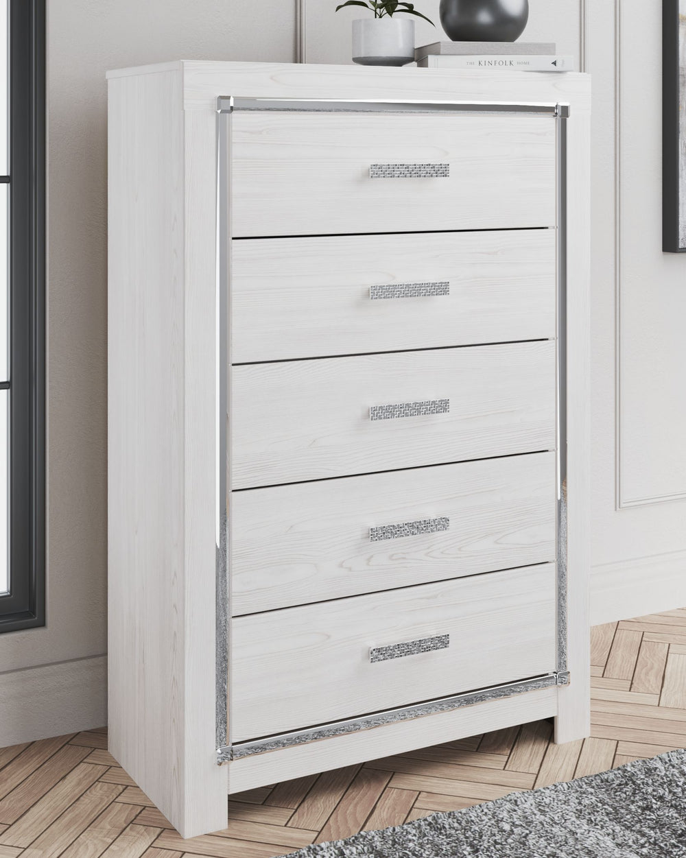 The epitome of fashion-forward design, this chest of drawers is a beautiful blend of style and luxury. Shiny chrome-tone accents, a pearlized finish and mosiac pulls bring a glam touch to the richly rustic appearance. Five smooth-gliding drawers provide p