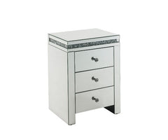 The Noralie Accent Table will give any room a touch of glamour. Mirror and glass materials give it a modern and clear touch while faux diamond inlays add glam style to this piece. Use this unique piece as the perfect accent for any room dÃ©cor. It has thr