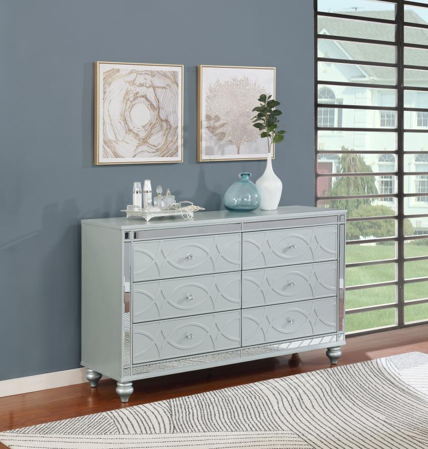 Give your home a modern glam update to classic design with this transitional six-drawer dresser. It features a glitzy design that takes center stage in any modern bedroom. It-'s fashioned with a vibrant silver metallic finish with fret work detail on the 