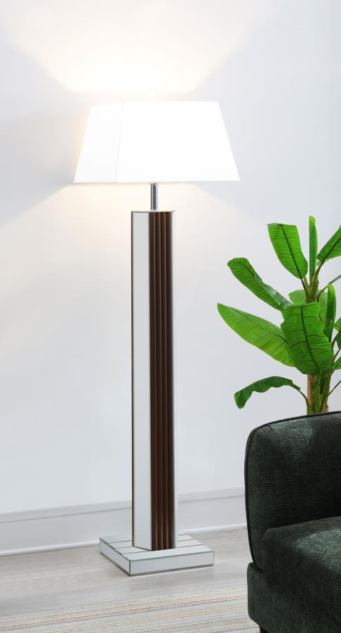 Introduce a dose of character and sophistication with a modern floor lamp. It boasts a chic towering silhouette, complete with a deep brown finish and scallop details that create a fresh touch of texture and dimension. Mirrored panels add contrast and bri