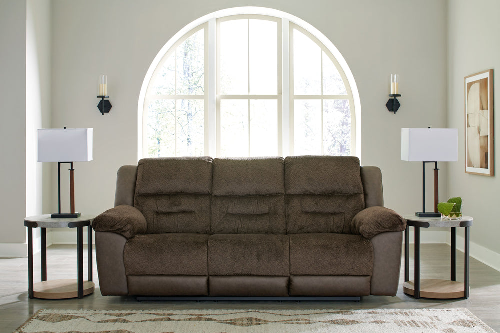 The Dorman sofa features soft-to-the-touch upholstery along with a dramatic style that steals attention. Featuring effortless reclining, it offers easy comfort for relaxation. This sofa is in a league of its own. All that-'s missing is you.<br><br><b>Addi