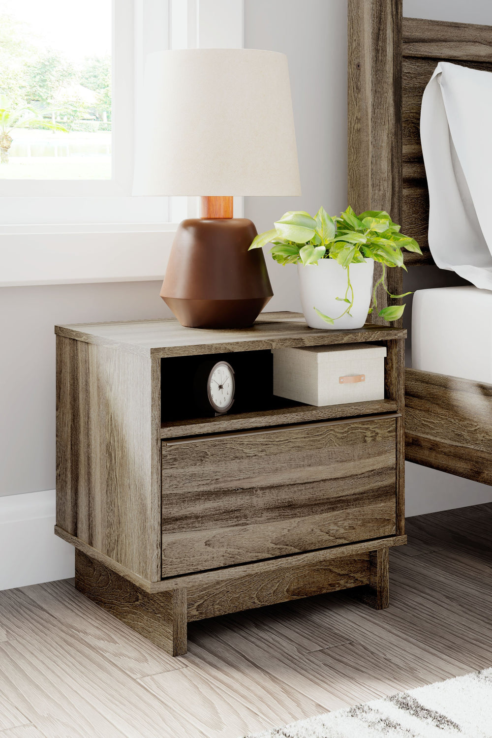 Your modern sanctuary is within reach. The subtle design of this nightstand is accented with a low profile base. Its weathered brown finish is complemented with refined champagne-colored handles on the smooth-gliding drawers. An open shelf provides additi
