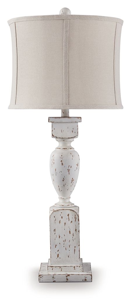 This table lamp takes a classic approach to tasteful lighting. Its detailed base ushers an air of elegance into your space with a graceful turn design. Outfitted with an antiqued white finish, it-'s right at home in traditional spaces. Pair with the match