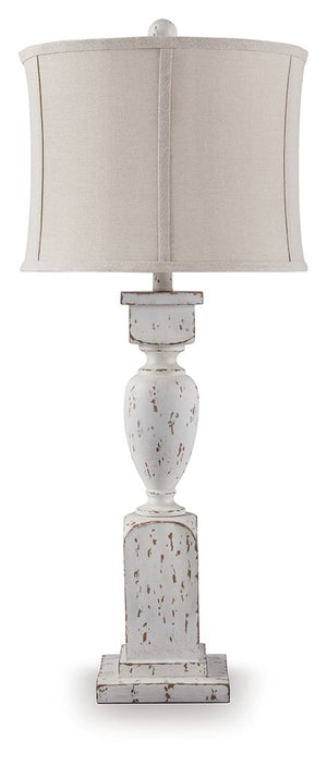 This table lamp takes a classic approach to tasteful lighting. Its detailed base ushers an air of elegance into your space with a graceful turn design. Outfitted with an antiqued white finish, it-'s right at home in traditional spaces. Pair with the match