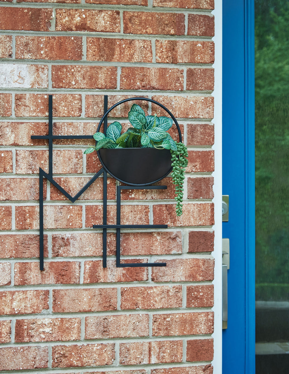 Create an interesting focal point in your indoor or outdoor space with this wall planter. A sculpted metal frame spelling the word -"Home-" houses a single planter to display herbs, succulents, small plants or greenery to complement your existing decor.<b
