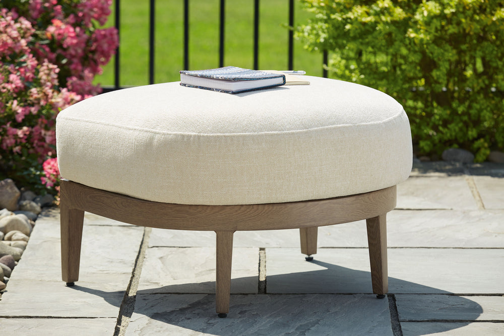 Elevate the appeal of easy-breezy living with this outdoor ottoman. Made to look like wood yet durable enough to weather the elements, it-'s sure to serve you and your besties well, year after year. The gentle curve of the frame is echoed in the cushion, 