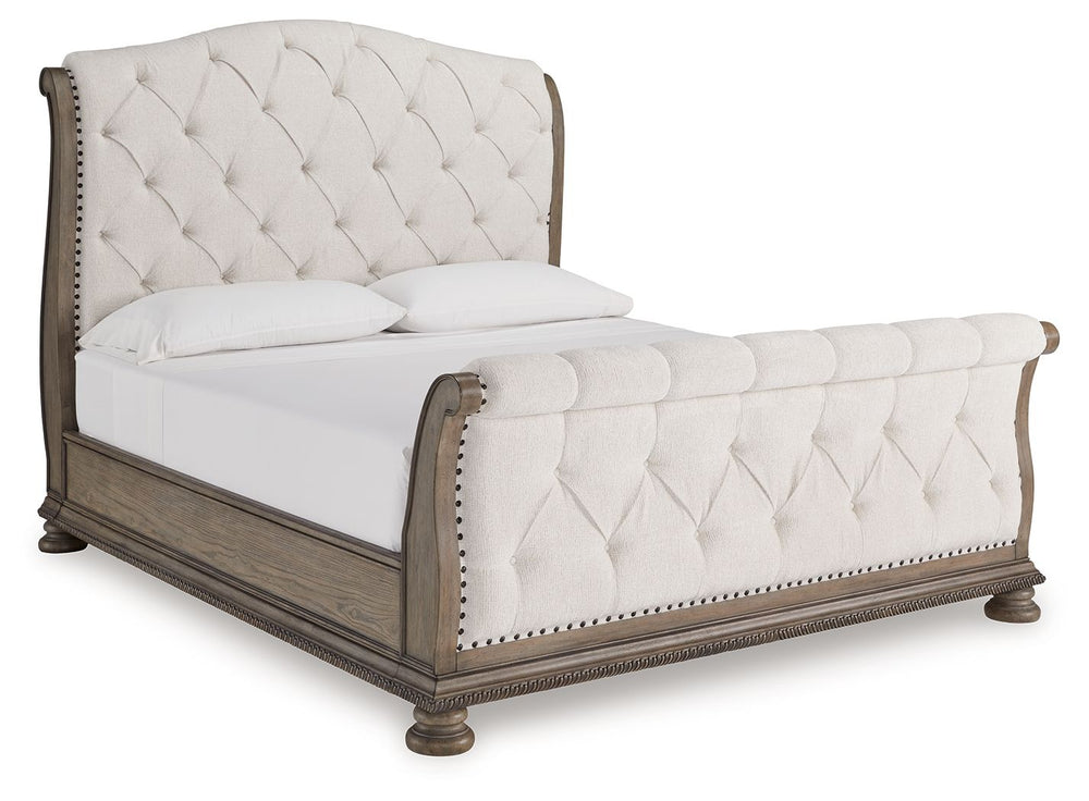 Merging traditional elegance with modern comfort, this California king upholstered sleigh bed takes your bedroom retreat to the next level. It radiates timeless sophistication with its shapely curves, glazed antiqued-look finish and tufted cushions. Talk 