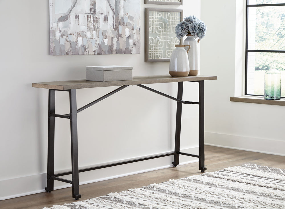 Delight in the effortless two-tone look of this long counter table. Dark iron-tone metal and distressed brown wood pair for a rustic look with modern sensibility. This charming piece is great for small spaces, easily tucking against a wall or the back of 