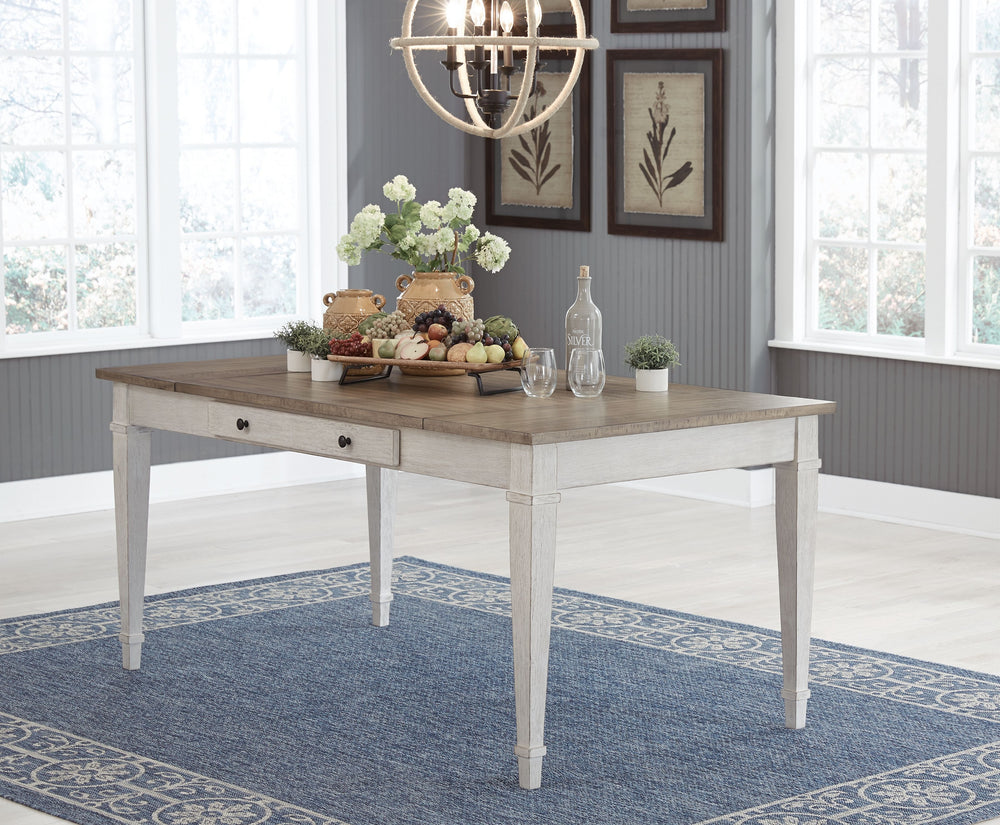 Set the scene for coastal chic or modern farmhouse living with this dining room table. Clean-lined, simply striking table doubles the charm with a brown tone top with plank effect, paired with a grayish white base with rub through effect for timeworn appe