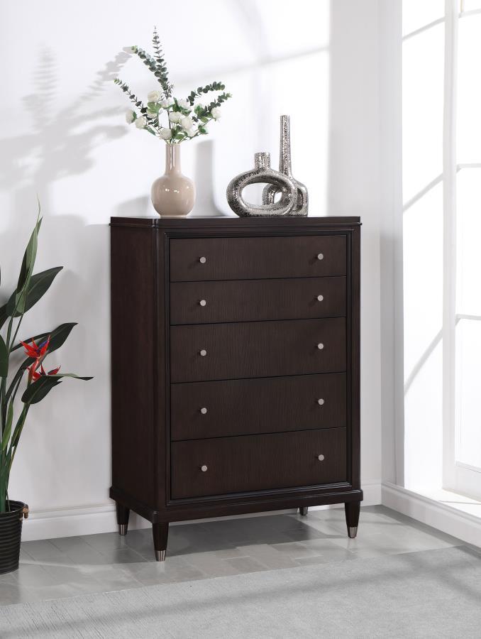 Gleaming knobs and foot caps add contrast and character to a modern five-drawer chest. Its deep brown finish is sleek and refined, perfect for a stylish bedroom with sophisticated presence. Its five drawers offer abundant storage. The top drawer includes 