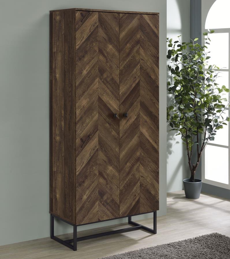 This tall storage cabinet blends rustic charm with modern utility, featuring a rustic oak finish and herringbone-patterned door fronts. Made from engineered wood with a scratch-resistant and eco-friendly laminate veneer, it includes multiple fixed shelves
