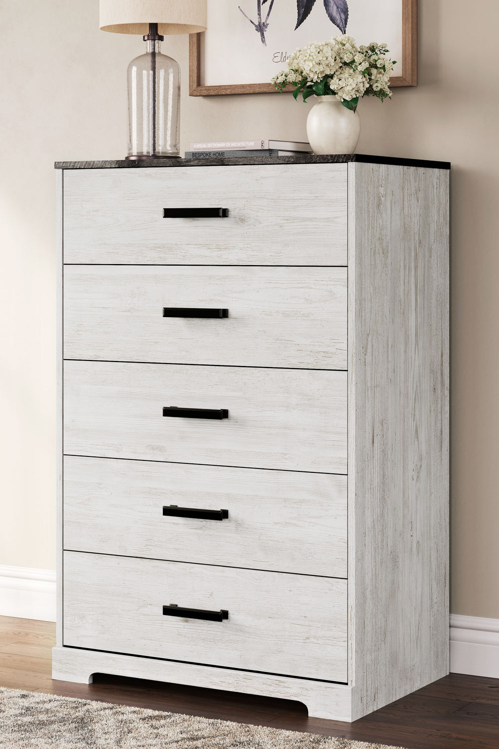 Give provincial a new meaning with the chic look of this chest of drawers. A two-tone finish keeps this piece light and fresh, while the warm pewter-tone hardware adds an industrial touch. The distressed whitewashed body adds a delightfully homespun charm