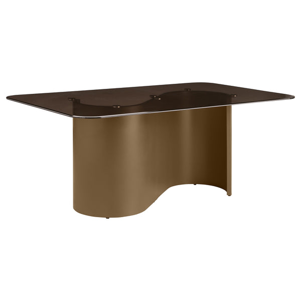 This bold dining table brings modern sophistication to your dining space with its striking design and luxurious finishes. The semi-opaque tempered glass top, finished in a rich tawny hue with rounded corners, beautifully contrasts the flowing, sculptural 