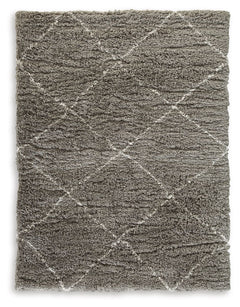 When is a rug more than a rug? When it invites you to kick off your shoes and stay a while. This shag rug welcomes visitors with warmth and a tantalizingly thick, plush pile. Its neutral color palette exudes a casually cool vibe that works wonders whereve