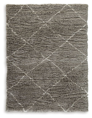 When is a rug more than a rug? When it invites you to kick off your shoes and stay a while. This shag rug welcomes visitors with warmth and a tantalizingly thick, plush pile. Its neutral color palette exudes a casually cool vibe that works wonders whereve