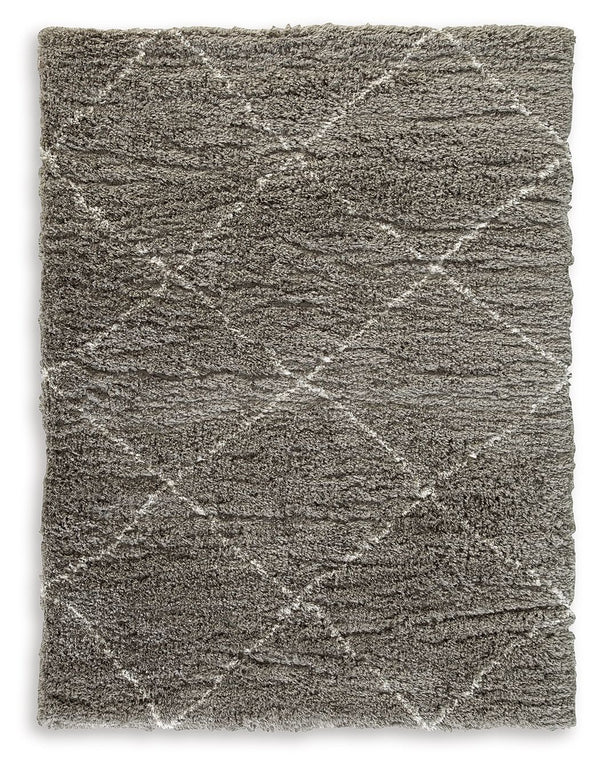When is a rug more than a rug? When it invites you to kick off your shoes and stay a while. This shag rug welcomes visitors with warmth and a tantalizingly thick, plush pile. Its neutral color palette exudes a casually cool vibe that works wonders whereve