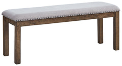 This upholstered dining bench elevates the art of casual rustic style. With a distressed nutmeg finish, antiqued nailhead trim and textured polyester fabric, this upholstered dining bench entices with warmth and earthy elegance. Cushioned seat accommodate