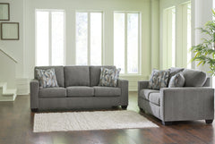 Youâ€™re in for a neat treat with this living room set. Its comfy seats are covered in soft, textural upholstery, and the wide track arms are eager to support your quest for total relaxation. Distressed abstract toss pillows bring a fresh breath of contem