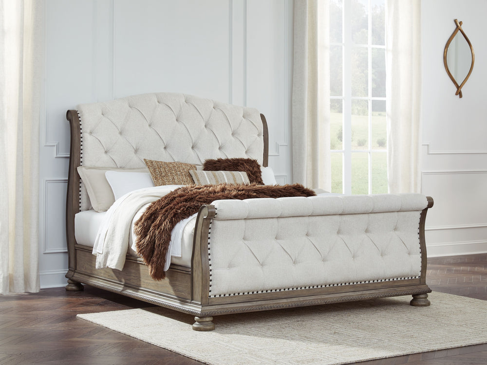 Merging traditional elegance with modern comfort, this California king upholstered sleigh bed takes your bedroom retreat to the next level. It radiates timeless sophistication with its shapely curves, glazed antiqued-look finish and tufted cushions. Talk 