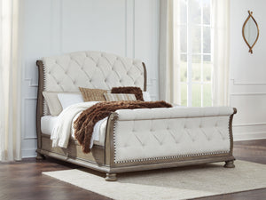  this California king upholstered sleigh bed takes your bedroom retreat to the next level. It radiates timeless sophistication with its shapely curves