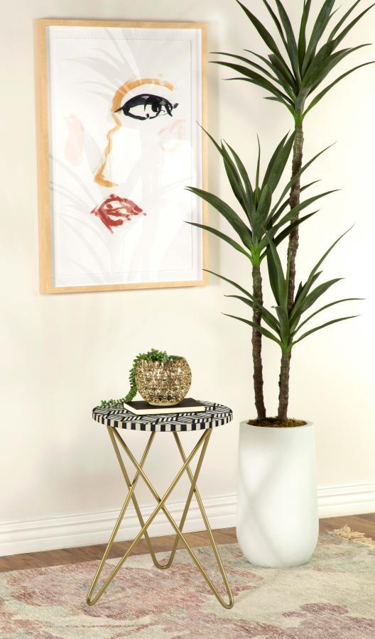 Make a bold statement with this elegant accent table, featuring a hand-inlaid bone and black resin mosaic that creates a striking geometric design. The round tabletop rests atop a sculptural butterfly-style hairpin metal base in a lustrous gold finish, ad