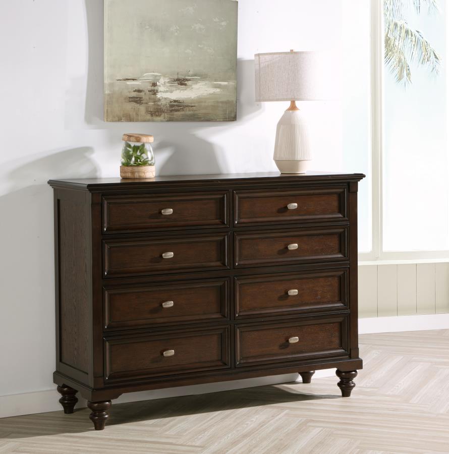 This eight-drawer dresser offers generous storage while maintaining an air of timeless sophistication. The dark oak finish accentuates the rich wood tones, while the gunmetal hardware adds a subtle, modern contrast. Each drawer features smooth metal exten