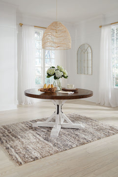 If you love rustic details full of charm and character, this dining room table is made with you in mind. Its two-tone distressed finish pairs a rustic brown tabletop with a vintage white base for fresh farmhouse styling. This round table features a sturdy