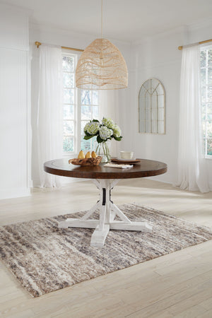 If you love rustic details full of charm and character, this dining room table is made with you in mind. Its two-tone distressed finish pairs a rustic brown tabletop with a vintage white base for fresh farmhouse styling. This round table features a sturdy