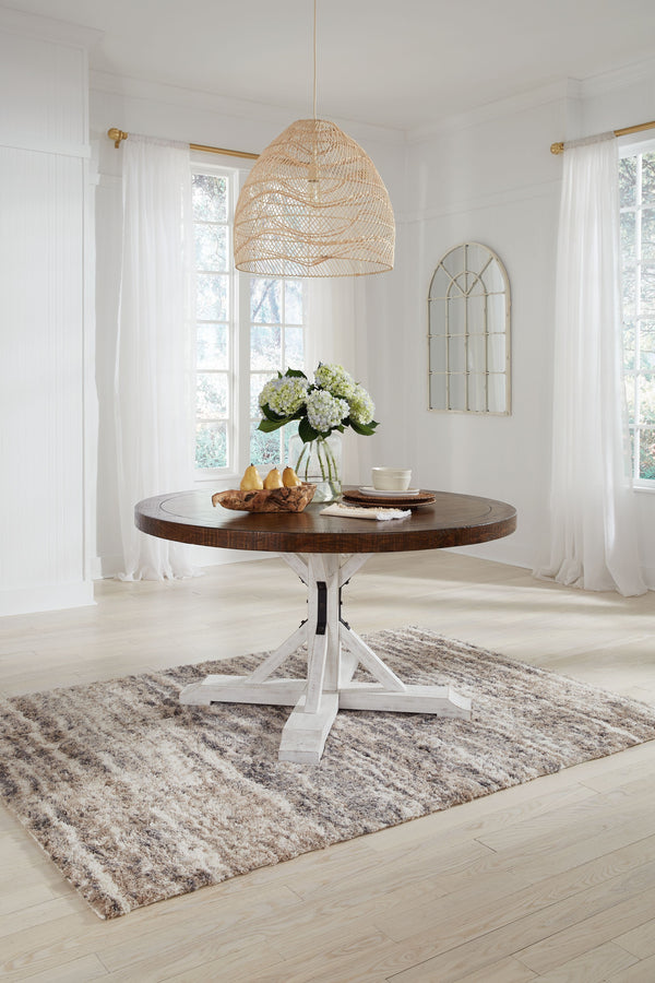 If you love rustic details full of charm and character, this dining room table is made with you in mind. Its two-tone distressed finish pairs a rustic brown tabletop with a vintage white base for fresh farmhouse styling. This round table features a sturdy