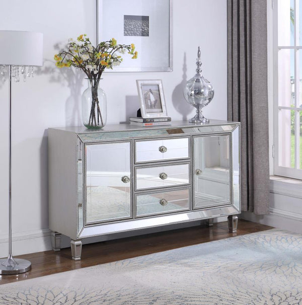  featuring dazzling mirrored panels and elegant beaded trim. Designed with three center drawers and two side doors