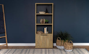  a charming media tower bookcase adds both open display space and hidden storage in your inviting living room. Featuring a melamine paper finish that resembles mango wood