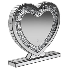 This heart-shaped table mirror blends glam style with practical lighting, perfect for vanities or dressing areas. The mirrored frame features an inset of faceted acrylic crystal inlay that catches light beautifully, while integrated LED illumination adds 