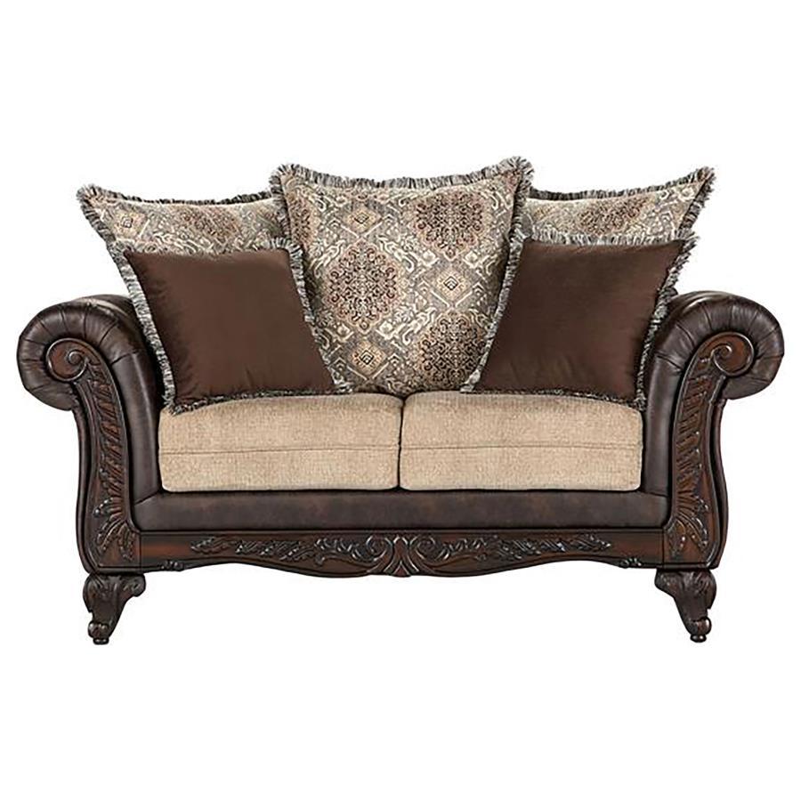 Bring robust design and a veritable tapestry of color and pattern to your living room with this traditional loveseat. It stands out with dramatic rolled arms augmented with smooth dark brown faux leather that adds depth and contrast to coordinating fabric