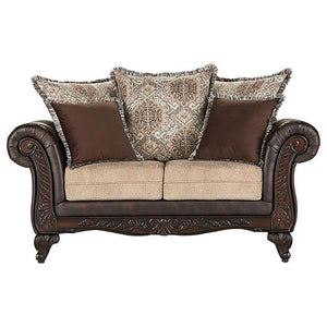 Bring robust design and a veritable tapestry of color and pattern to your living room with this traditional loveseat. It stands out with dramatic rolled arms augmented with smooth dark brown faux leather that adds depth and contrast to coordinating fabric