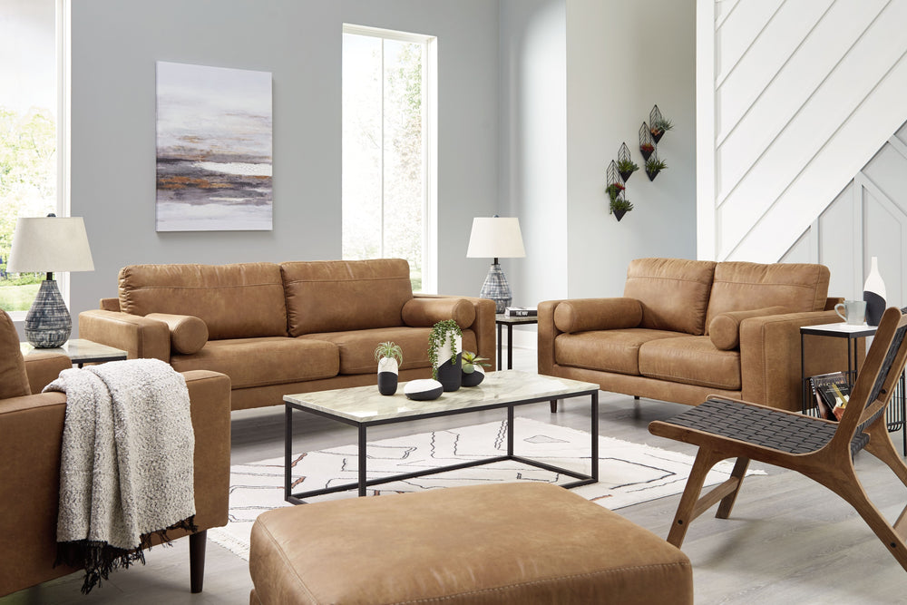 Small-scale style, tailored to perfection. This seating package echoes retro aesthetics with warm caramel faux leather, while its ultra-linear silhouettes incorporate a contemporary edge. Versatile in form and function, this set suits styles from modern b