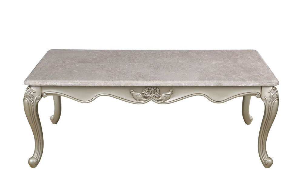 The Monique Royal Classic Cocktail Table in champagne epitomizes heirloom-quality craftsmanship and timeless elegance. Expertly constructed from premium pine solids and adorned with durable polyurethane carvings, this coffee table is lightweight, moisture