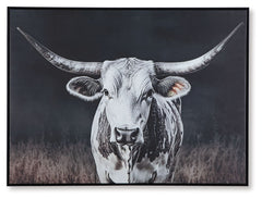 Add homespun charm to modern farmhouse and casual spaces. A longhorn cow takes center stage in this wall art, its white coat contrasting beautifully against the dark background tones. A sleek black frame completes the look.<br/><br/><b>Product Features</b