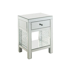 The Nysa Accent Table will give any room a touch of glamour. Mirrored finish and glass surfaces give it a modern and clear touch while faux crystals inlays add glam style to this piece. Use this unique piece as the perfect accent for any room dÃ©cor. It h