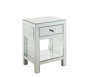 The Nysa Accent Table will give any room a touch of glamour. Mirrored finish and glass surfaces give it a modern and clear touch while faux crystals inlays add glam style to this piece. Use this unique piece as the perfect accent for any room dÃ©cor. It h