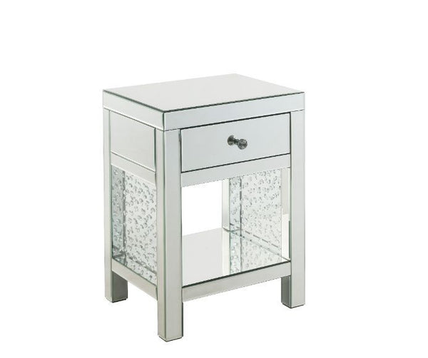 The Nysa Accent Table will give any room a touch of glamour. Mirrored finish and glass surfaces give it a modern and clear touch while faux crystals inlays add glam style to this piece. Use this unique piece as the perfect accent for any room dÃ©cor. It h